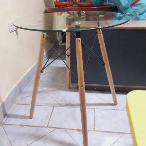 Round glass dining table with wooden stands