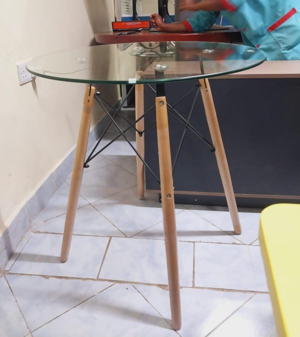 Round glass dining table with wooden stands