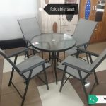 Round outdoor dining table with fold-able seats