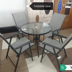 Round outdoor dining table with fold-able seats