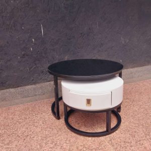 A modern coffee side table with a black top