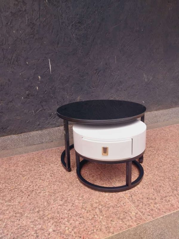 A modern coffee side table with a black top